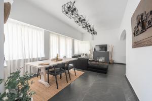 a living room with a table and a couch at Garden Villa Glyfada in Athens