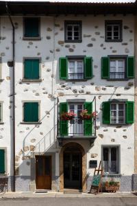 un edificio bianco con persiane verdi e balcone di B&B22 a Santa Brigida