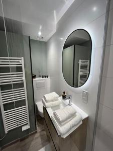 a bathroom with a sink and a mirror at Pour une nuit douce 