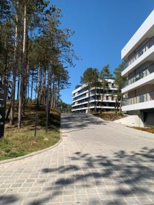 an empty road in front of a building at Shellter Apartments By the Sea Rogowo in Rogowo