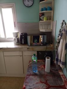 a bottle of water sitting on a table in a kitchen at Appartement 2 chambres Yoff Virage Dakar Senegal in Dakar