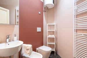 a bathroom with a sink and a toilet and a mirror at Livorno Central Flat-2 min walk the Cathedral! in Livorno