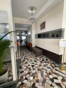 a lobby with a tiled floor in a building at Hotel Haway in Rimini