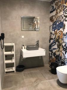 a bathroom with a sink and a toilet at Aliara Dilara Beach Apartments in Pomorie