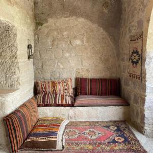 a small room with two cushions on a couch at Seven Rock Cave Hotel in Göreme