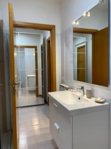 a bathroom with a sink and a mirror and a shower at Casa Valentina 2 in Perugia