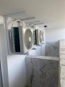 a kitchen with two microwaves hanging on a wall at ΧΑΝΙΟΤΗ LUXURY STUDIOS 2 FIRST SEA BY MAKHMOME in Hanioti