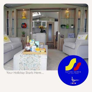 Seton Sands Holiday Home في Port Seton: غرفة معيشة مع أريكة وطاولة
