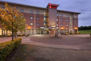 a large building with a sign on the front of it at Ramada Plaza Wrexham in Wrexham