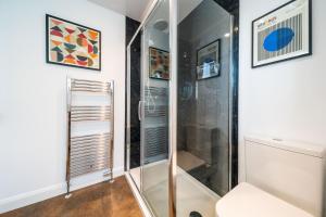 a shower with a glass door in a bathroom at Westland Shores in Crail