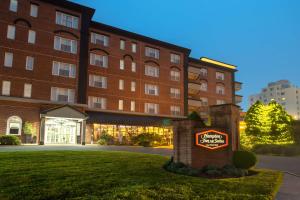 a hotel with a sign in front of a building at Hampton Inn & Suites Stamford in Stamford