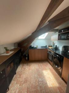 a kitchen with a vaulted ceilings and a kitchen with a washer at Loft apartment at Villa Leonie in Hyères
