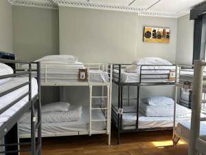 a room with three bunk beds in a room at Lagan Backpackers in Belfast