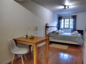 a bedroom with a bed and a desk and a table at Alto Atardecer in San Martín de los Andes