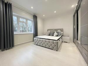 a bedroom with a large bed and a television at The Elegance in Chatteris