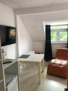 a living room with a white table and a couch at Viking in Dziwnów