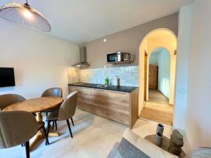 a kitchen with a table and a dining room at Fantažija Apartment in Brodarica