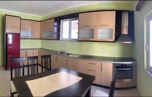 a kitchen with a table and a stove top oven at STEFAN VASILI in Sarandë +6 photos