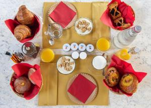 a table with breakfast foods and drinks and orange juice at Villa Monteporzano in Orvieto