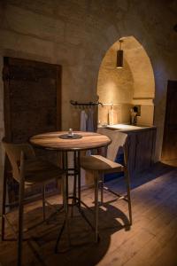 uma cozinha com mesa e cadeiras num quarto em Hôtel particulier Fénelon (XIIIe) em Sarlat-la-Canéda