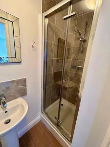 a bathroom with a shower and a sink at Inn Glastonbury - Self Catering in Glastonbury