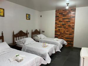 מיטה או מיטות בחדר ב-POUSADA PALIPALAN