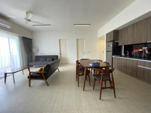 a living room with a table and a couch at By The Sea@Sunset view and Seaview #32 in Batu Ferringhi