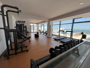 a gym with several treadmills and a view of the ocean at Summer Briva by Infinity -Mamaia Nord-Sea View-Private Parking in Mamaia Sat/Năvodari