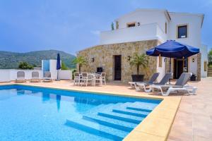 a villa with a swimming pool and a house at Villa La Sella by Rock Rentals in Muntanya la Sella