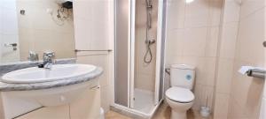 a bathroom with a shower and a toilet and a sink at Estudio Jávea Park Arenal in Jávea
