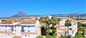 a view of apartment buildings with a mountain in the background at Estudio Jávea Park Arenal in Jávea