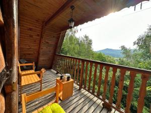 a porch of a cabin with a view of the mountains at Domek na górze z pięknym widokiem in Bukowiec