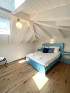 a bedroom with a blue bed in a attic at Tropicale in Rapallo