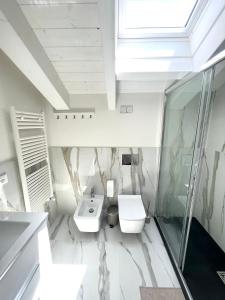 a bathroom with a sink and a toilet and a shower at Tropicale in Rapallo