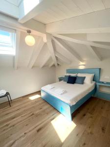 a bedroom with a blue bed in an attic at Tropicale in Rapallo
