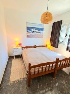 a bedroom with a large bed in a room at Natua Apartment in Krvavica +77 photos