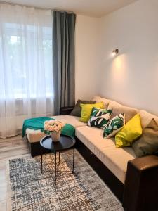 a living room with a couch and a table at Tammsaare 28 Beach Apartment in Pärnu