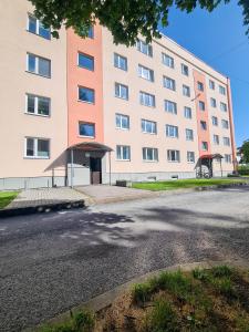 a large building with a street in front of it at Tammsaare 28 Beach Apartment in Pärnu