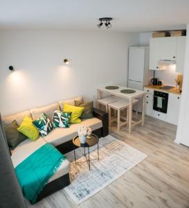 a living room with a couch and a kitchen at Tammsaare 28 Beach Apartment in Pärnu