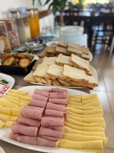 a table topped with different types of meats and cheese at Hotel Arenas Blancas in Federación