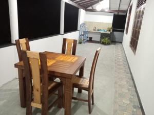 a wooden table and chairs in a room at Thisumi Guest in Weligama