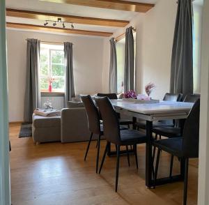 a living room with a table and chairs and a couch at Rebhaus Durbach in Durbach
