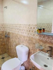 a bathroom with a toilet and a sink at Mira House in Martvili