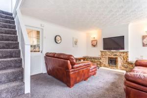 a living room with a couch and a fireplace at Delightful Garforth Home in Garforth