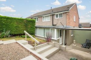 a house with a staircase in front of it at Delightful Garforth Home in Garforth