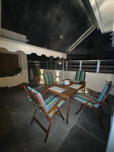 a wooden table and chairs in a living room at Hercules in Preveza