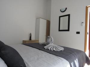 a bedroom with a large bed with a doll on it at Erika Medulin in Medulin