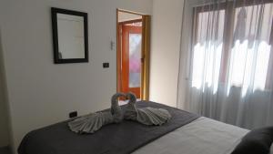 a swan sitting on a bed in a bedroom at Erika Medulin in Medulin