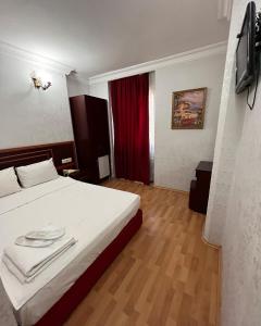 a bedroom with a bed with towels on it at Red White Hotel in Istanbul