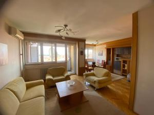 a living room with a couch and chairs and a table at Family Apartment in City Centre in Bitola